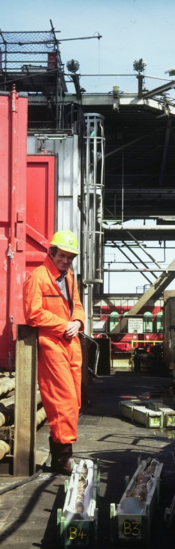 Figure 16: BP's Chief Sedimentologist pictured relaxing during core-recovery on the deck of Forties Delta on 17th May 1982. Note the immaculate and mud-free protective clothing.